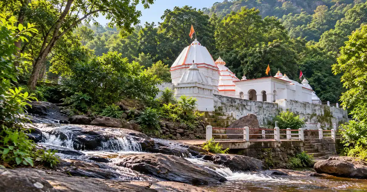 Illustrative Harishankar Temple beside a forest stream on the Gandhamardan foothills