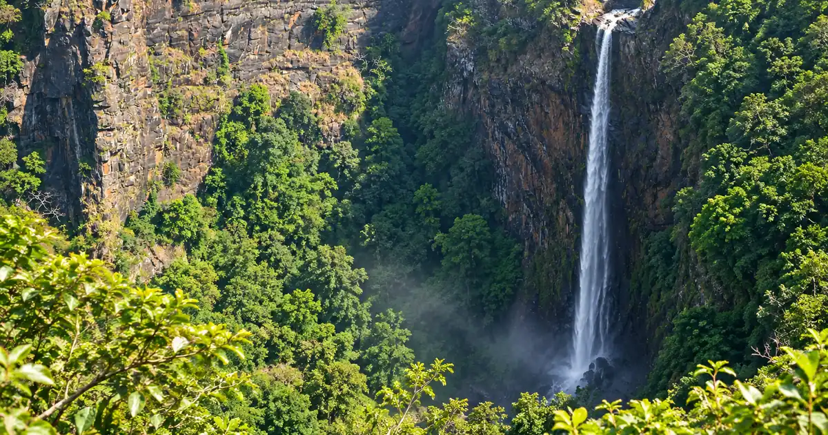 Single stream of Joranda Waterfall descending through a forested gorge