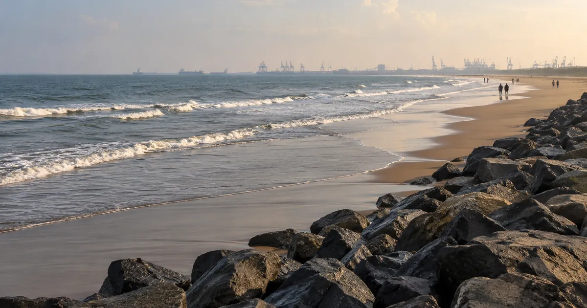 Low waves meet the boulder breakwater at Paradeep Sea Beach