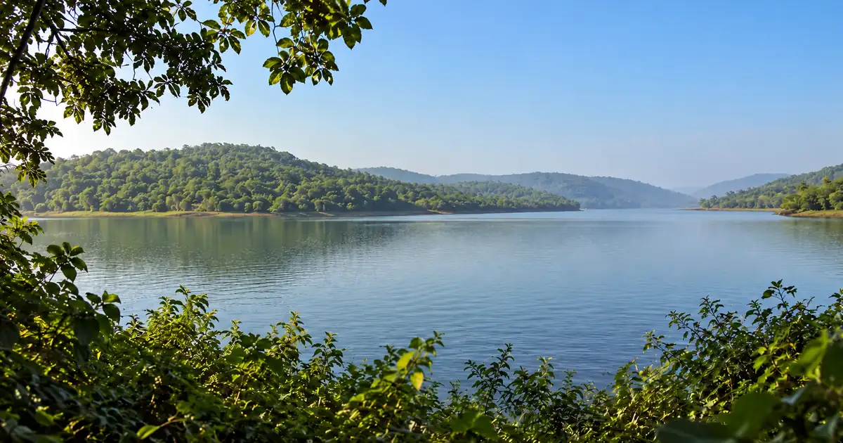 Still water and wooded hills at Deras reservoir near Bhubaneswar