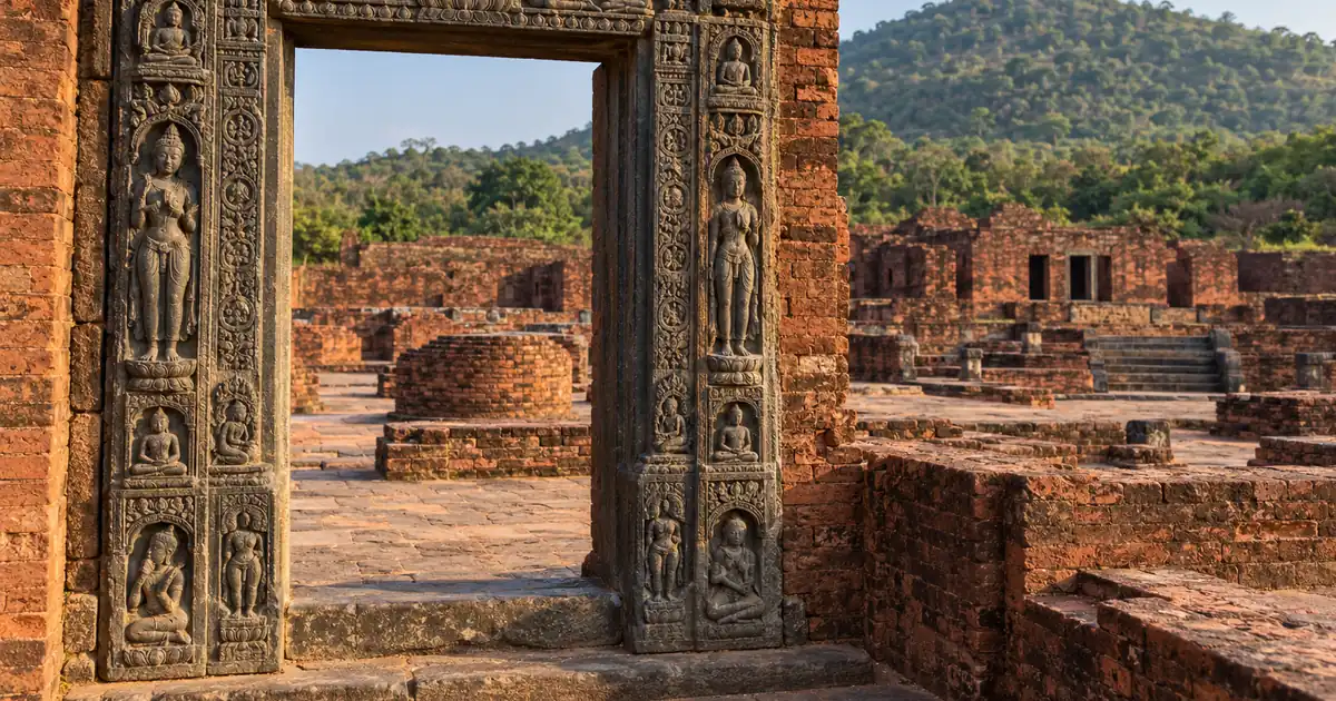Carved doorway of Monastery 1 opening onto the brick ruins at Ratnagiri