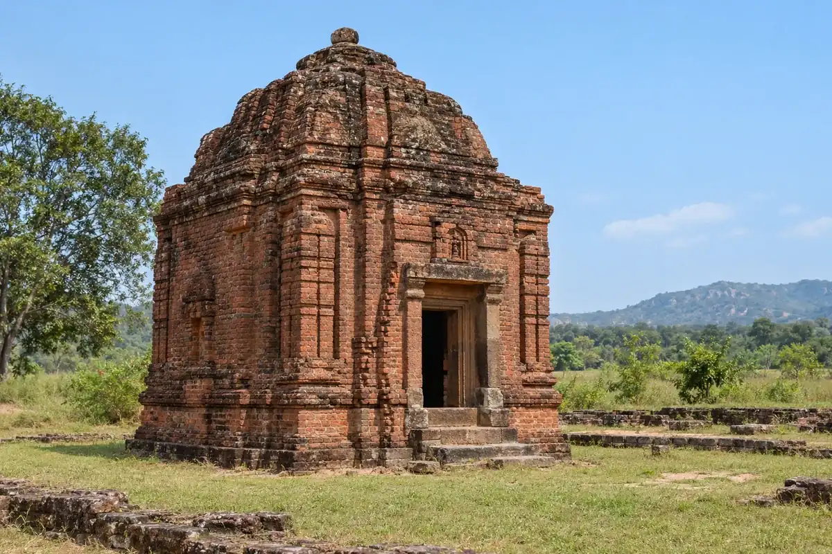 Weathered red-brick Indralath temple in the grassland at Ranipur Jharial