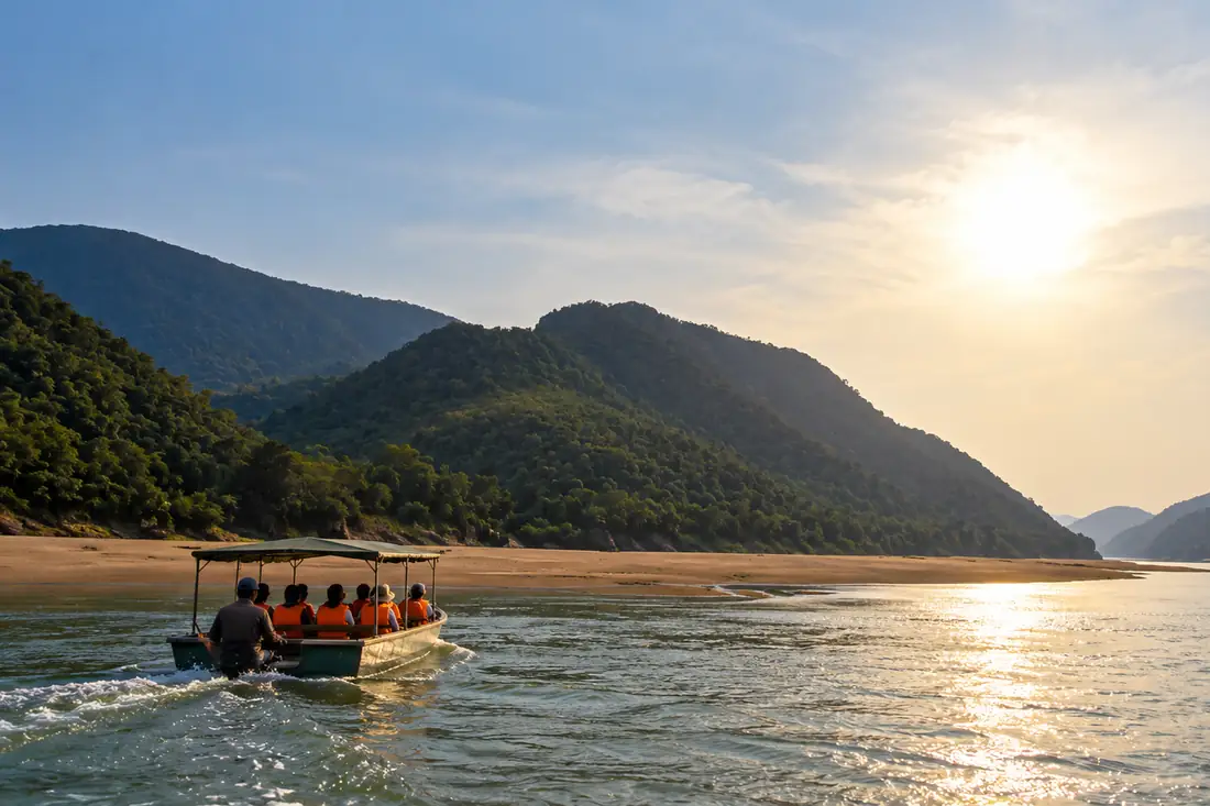Small boat crosses the Mahanadi between forested hills in Satkosia Gorge