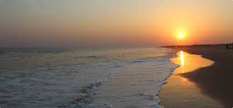 Sunset on Puri Beach with a line of gentle surf
