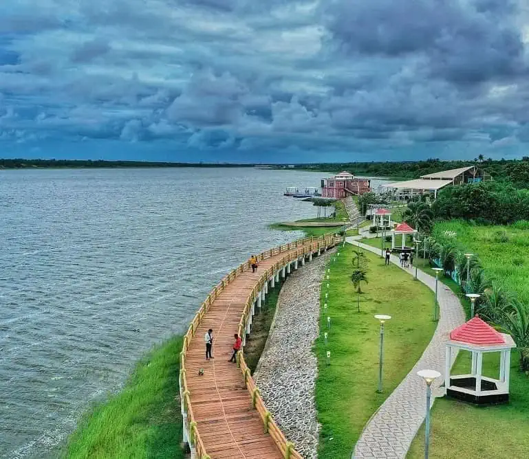 A breathtaking aerial view of Tampara Lake in Ganjam, showing the vast blue water and the lush green surrounding landscape.