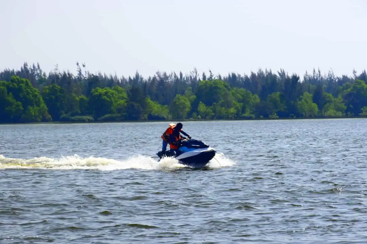 A visitor enjoying an adrenaline-pumping jet ski ride on the vast waters of Tampara Lake.