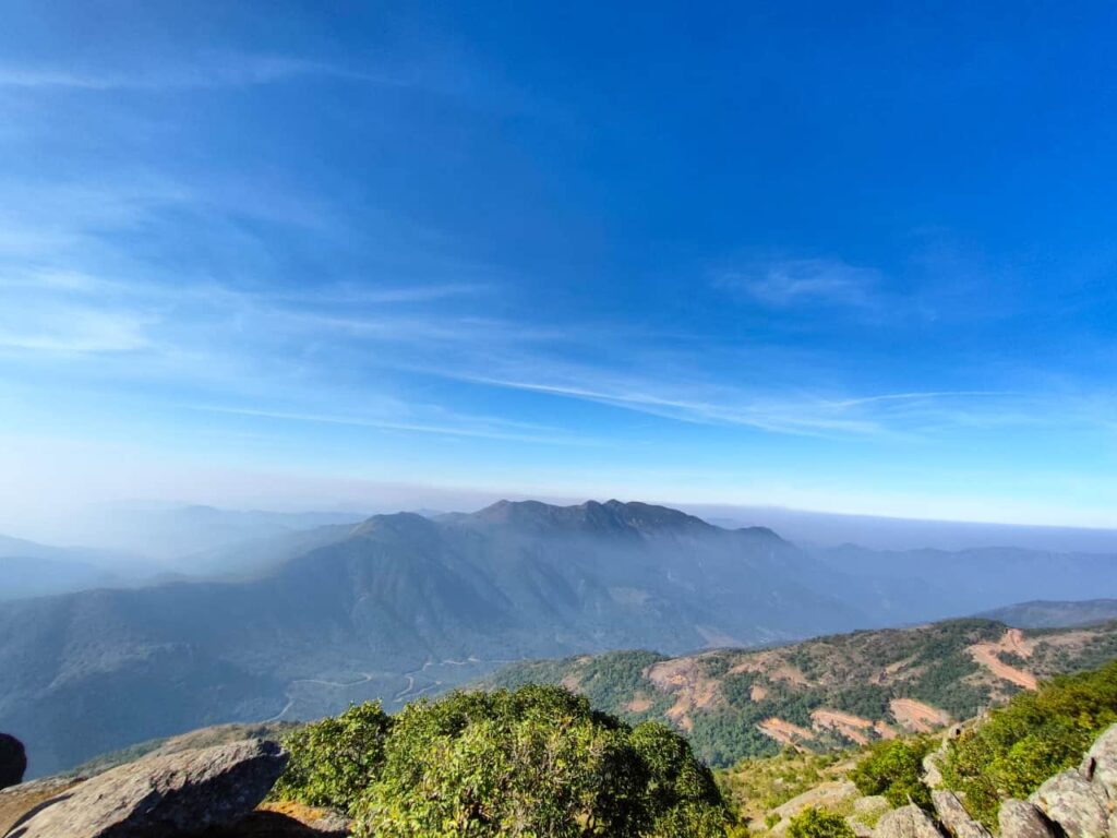 A breathtaking view of the Mahendragiri Hills landscape at dawn, showing the rolling peaks of the Eastern Ghats.