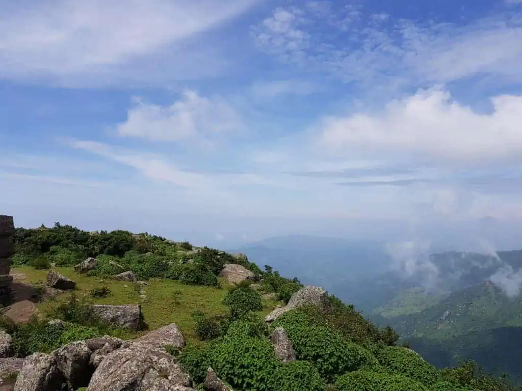 A scenic view of the Mahendragiri mountain range covered in lush greenery during the post-monsoon season.