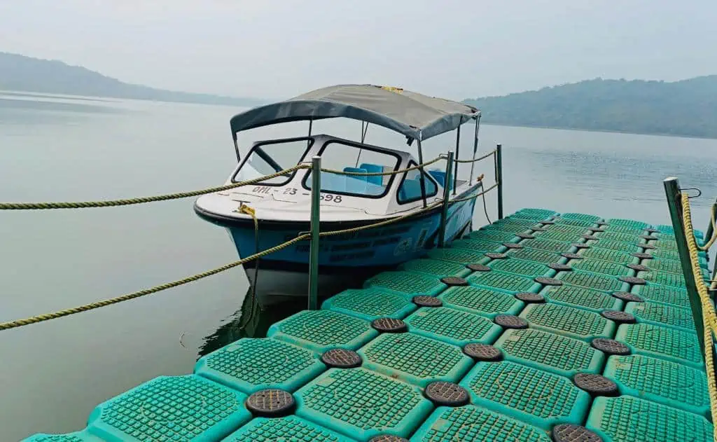 A boat rests beside the floating dock on Deras reservoir